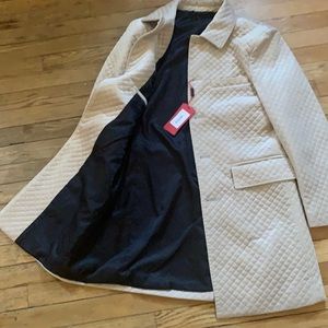 Cream pea coat. Milano is the brand. Never been worn